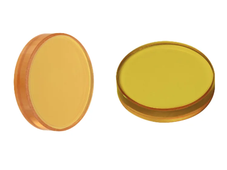 Round zinc selenide windows showing their characteristic yellow transparency